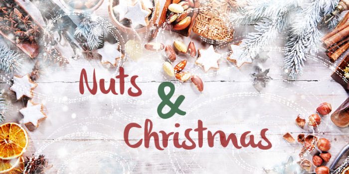 White Christmas Background with empty copy space. Cakes and nuts as a decorative xmas frame for xmas concept or cards